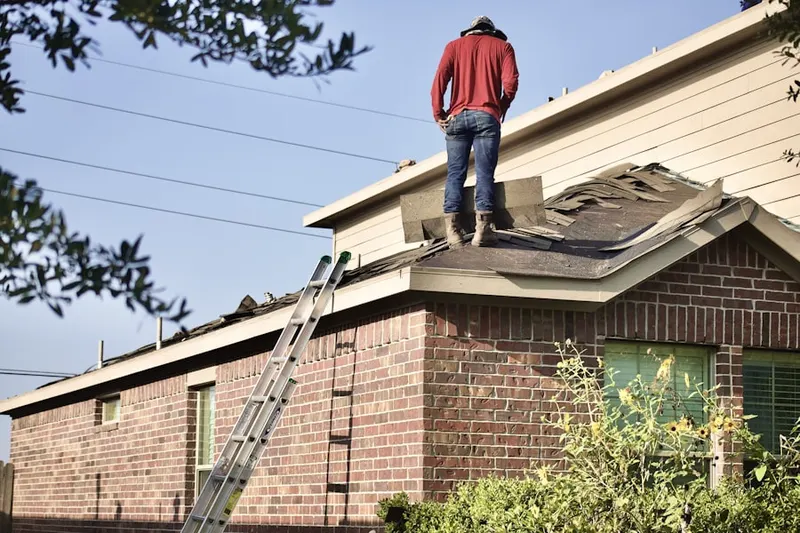 Professional roofer working on a residential roof in Huntington Beach